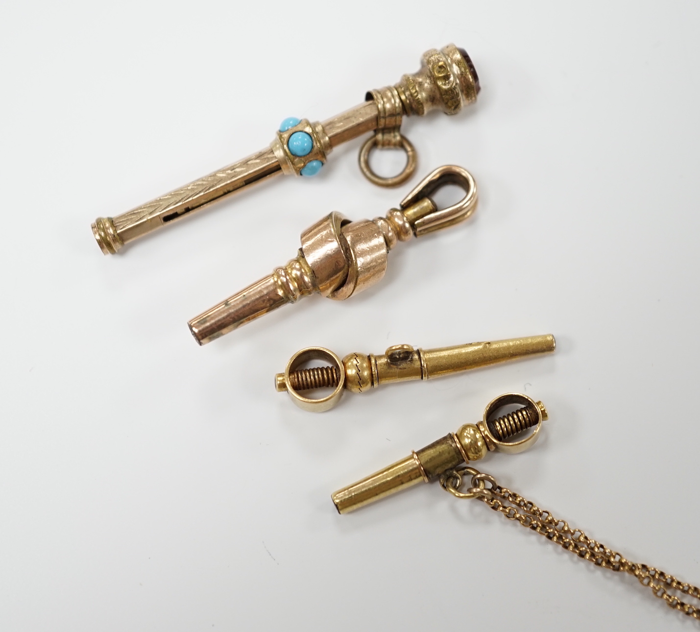Three 19th century yellow metal overlaid watch keys and a similar propelling pencil, 40mm.